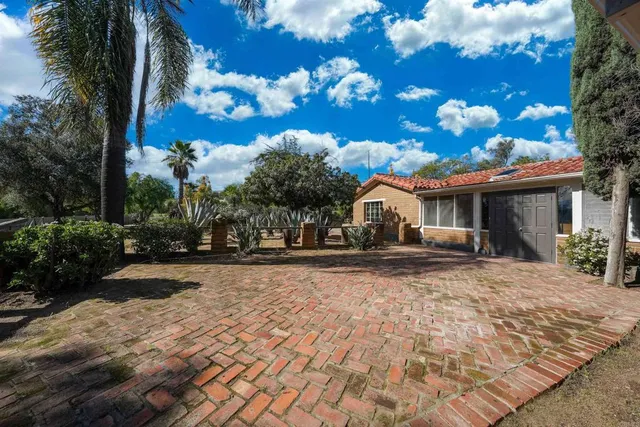 a front view of a house with yard porch and outdoor seating