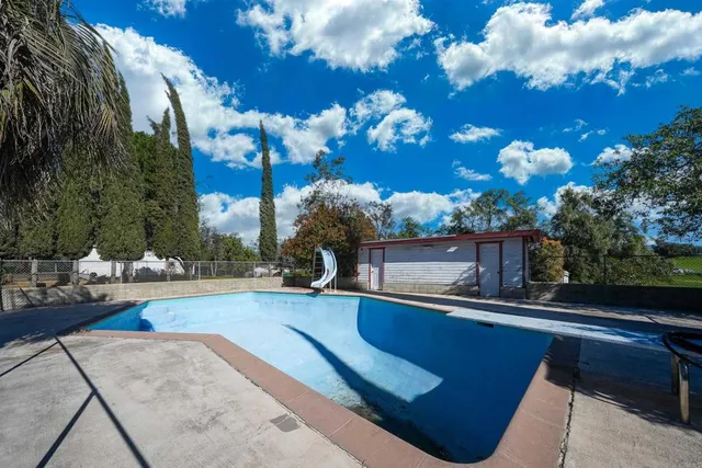 a view of swimming pool with a patio
