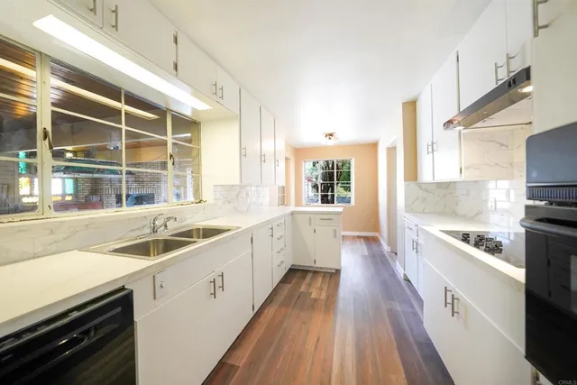 a kitchen with a sink stove microwave and refrigerator