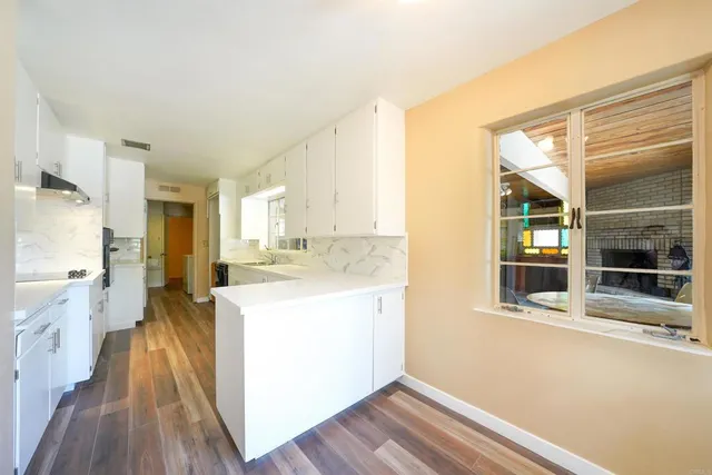 a view of a kitchen cabinets and wooden floor