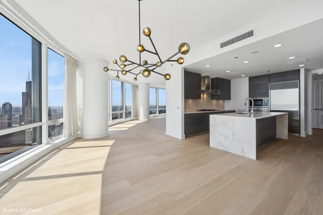 a view of a kitchen with a sink stainless steel appliances and cabinets