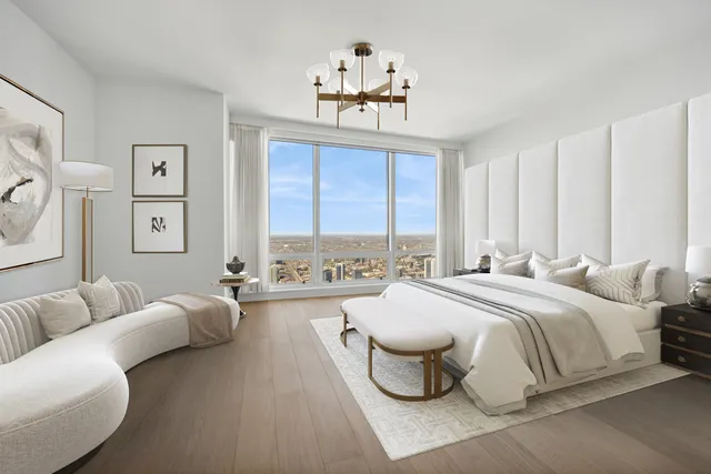 a spacious bedroom with a bed couch and a window