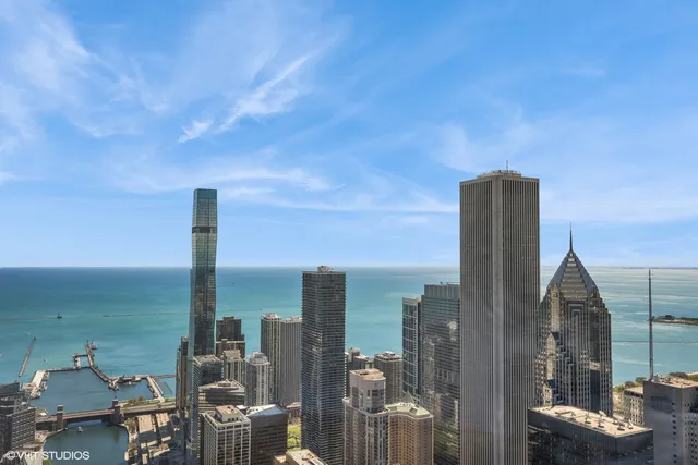 a view of a living room with a large window and wooden floor