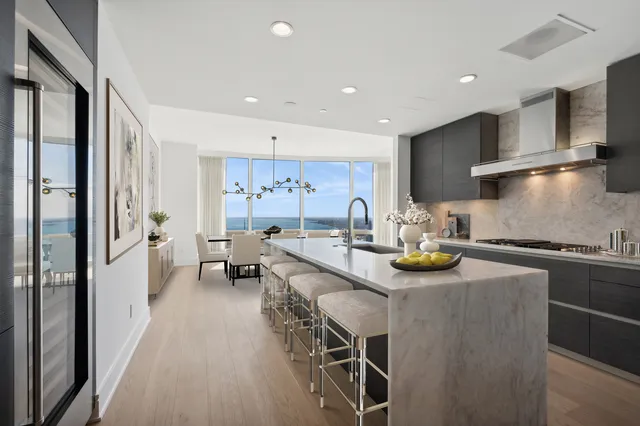 a kitchen with sink stove and cabinets