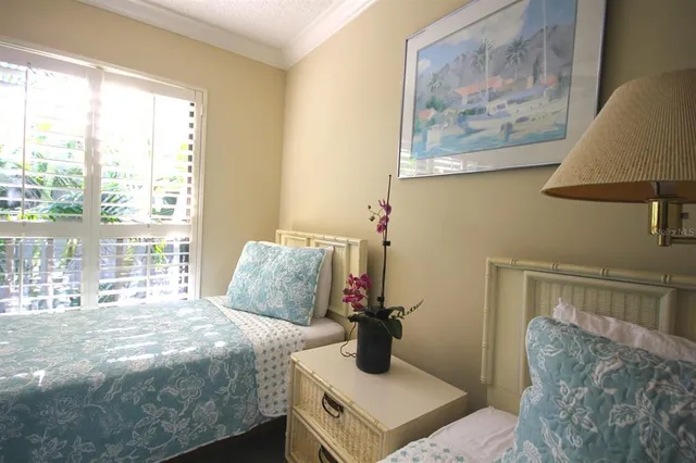 a bedroom with a bed and a painting on the wall