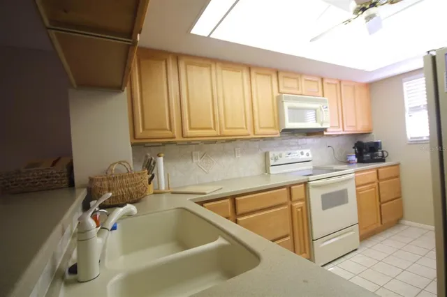 a kitchen with a sink cabinets and window