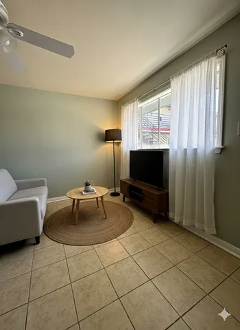 a living room with couches and a flat screen tv