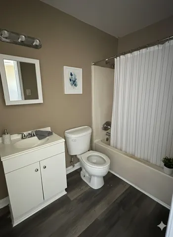 a bathroom with a toilet sink and mirror