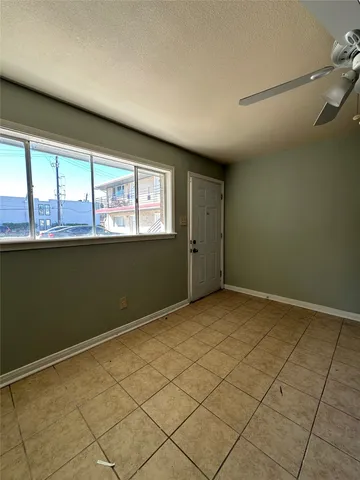 a view of a livingroom with an empty space and a window