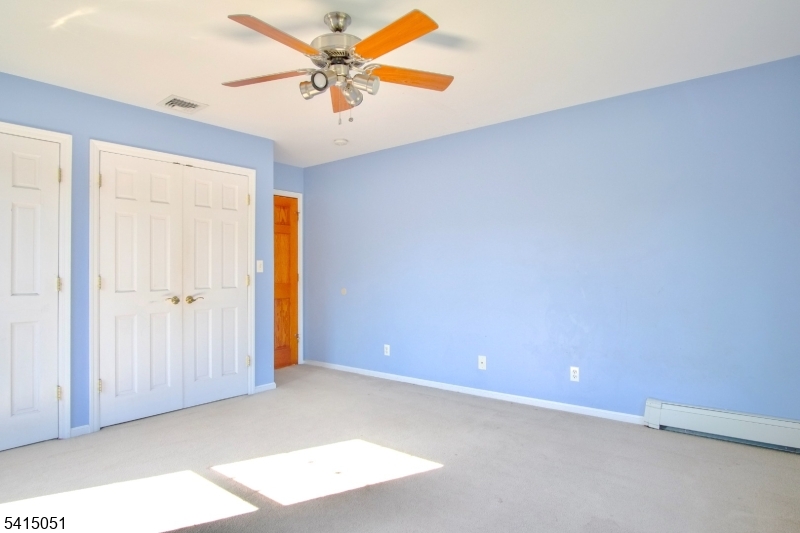 4 Budd Street Ledgewood, NJ 07852 - Photo 12 of 22 an empty room with a ceiling fan and carpet
