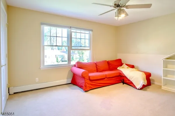 a living room with a bed and a chandelier