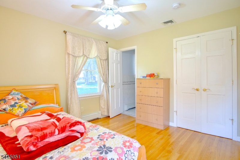 4 Budd Street Ledgewood, NJ 07852 - Photo 15 of 22 a bedroom with a bed and a chandelier
