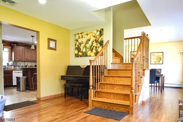 a view of a living room with furniture and wooden floor