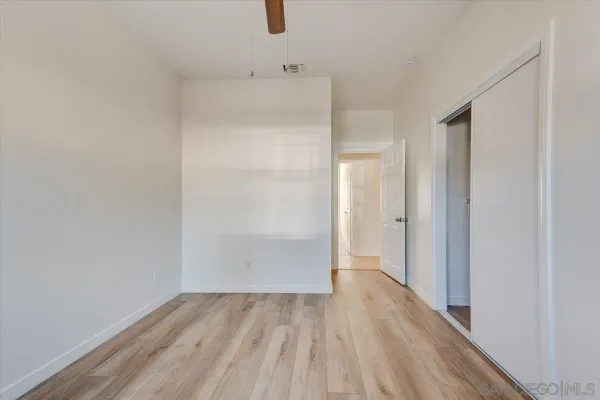 a view of a room with wooden floor