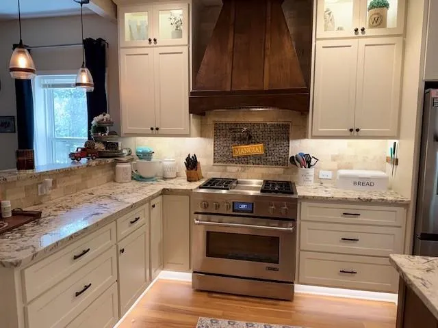 a kitchen with cabinets appliances and a sink