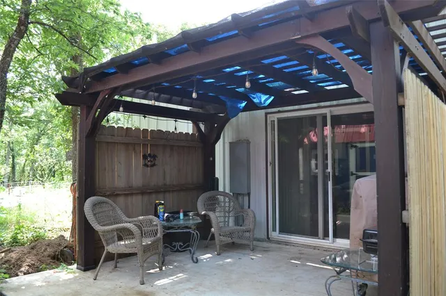 a backyard of a house with table and chairs