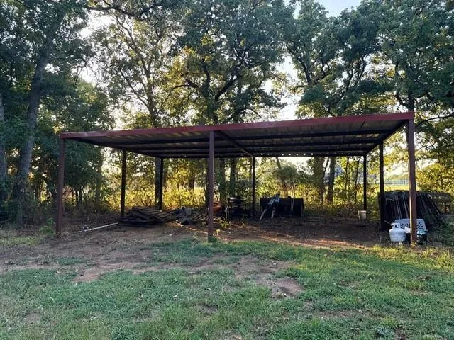 a backyard of a house with a table and chairs