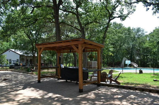 a view of a park with chairs and a yard