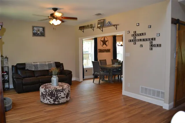 a living room with furniture and wooden floor