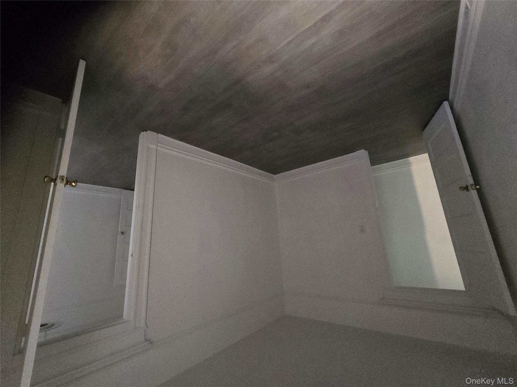 67 Radford Street, Unit 2E Yonkers, NY 10705 - Photo 14 of 19 an empty room with wooden floor and door