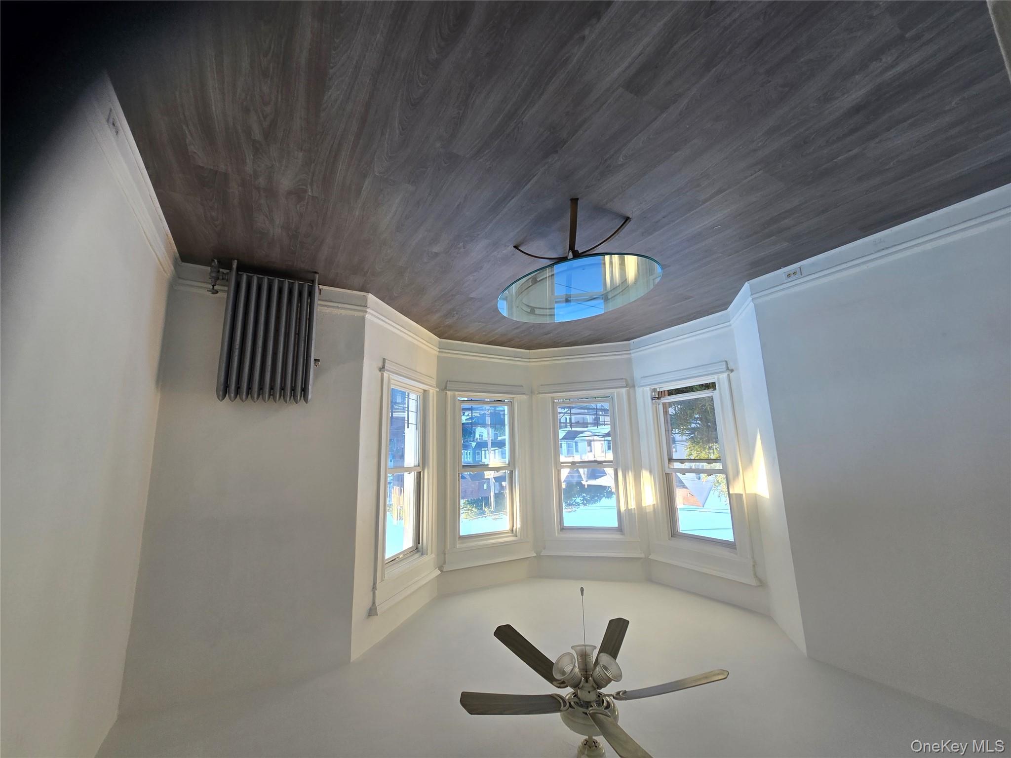 67 Radford Street, Unit 2E Yonkers, NY 10705 - Photo 17 of 19 an empty room with wooden floor and windows