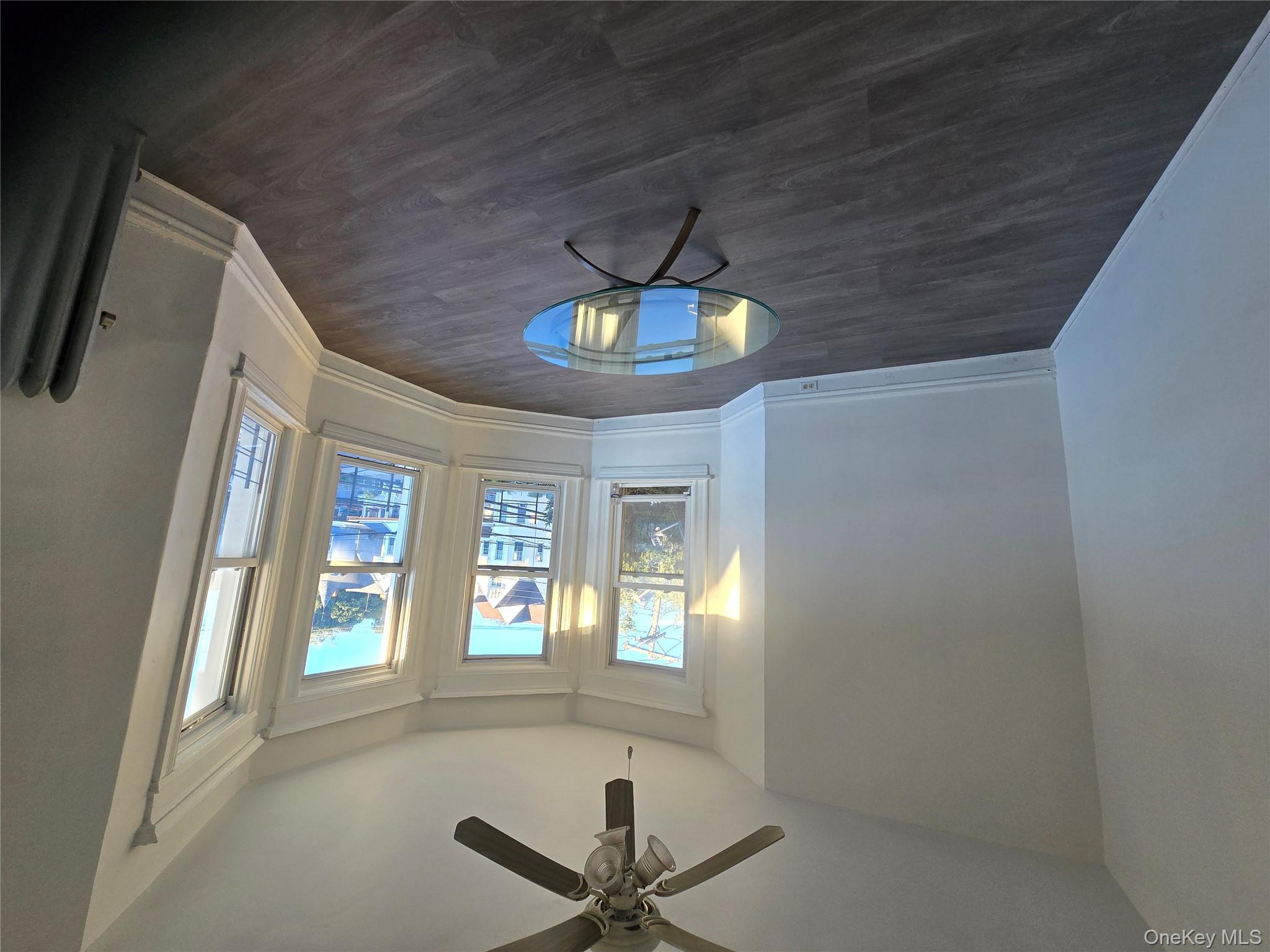 67 Radford Street, Unit 2E Yonkers, NY 10705 - Photo 18 of 19 a view of a livingroom with wooden floor and a window
