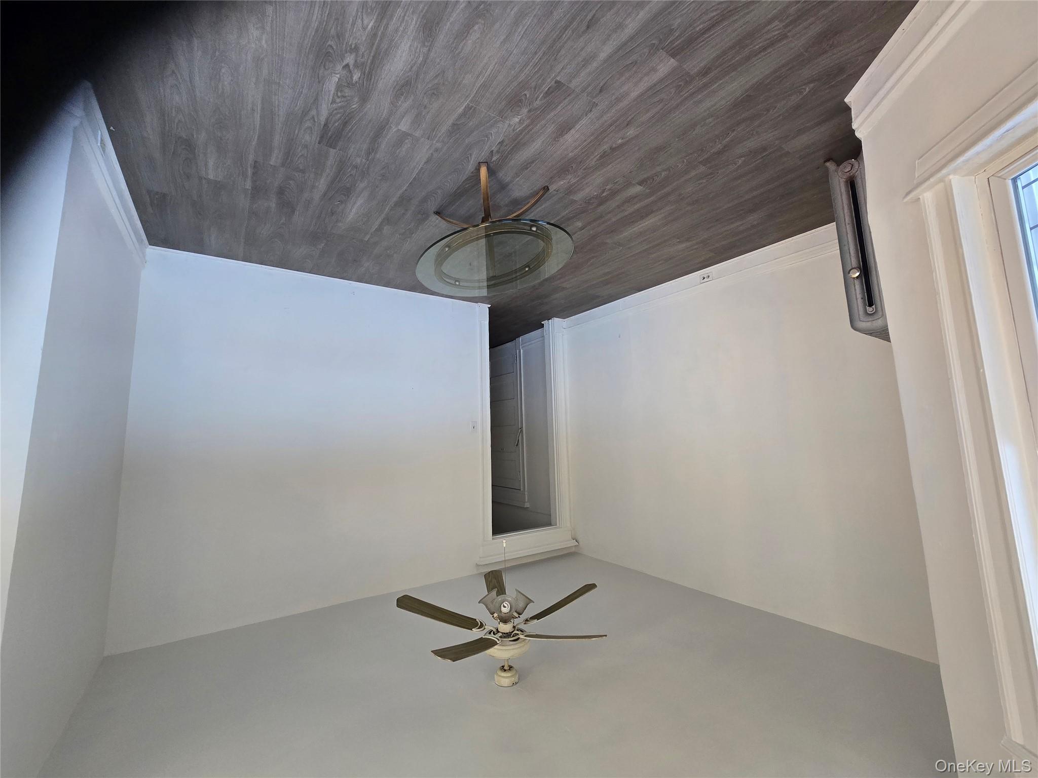 67 Radford Street, Unit 2E Yonkers, NY 10705 - Photo 19 of 19 a view of empty room with wooden floor and fan