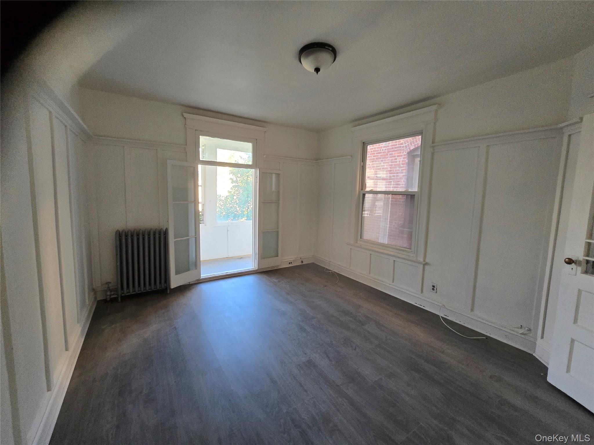 67 Radford Street, Unit 2E Yonkers, NY 10705 - Photo 3 of 19 a view of a livingroom with wooden floor and window
