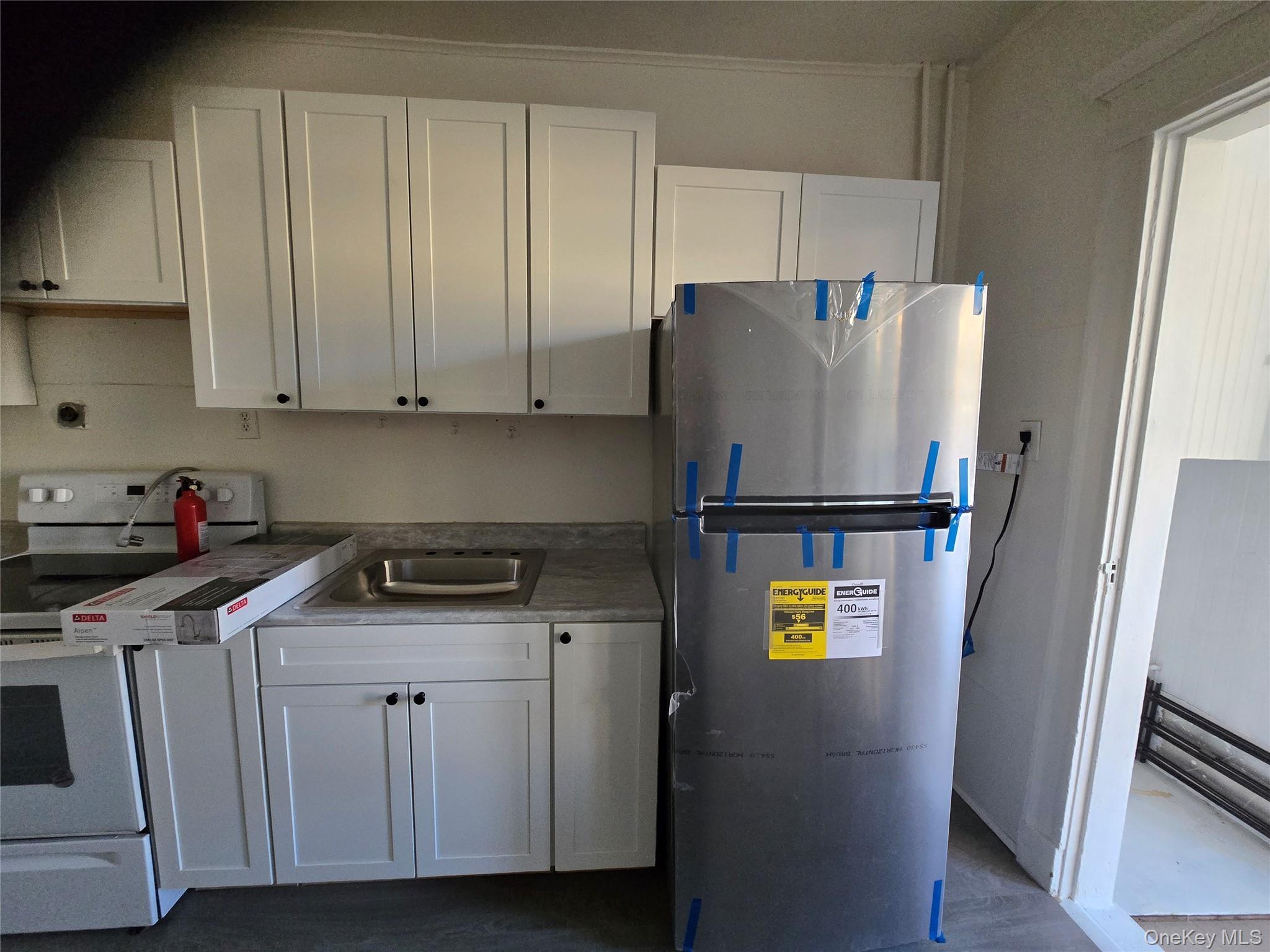 67 Radford Street, Unit 2E Yonkers, NY 10705 - Photo 9 of 19 a kitchen with a refrigerator and a stove top oven