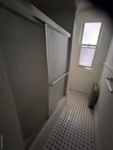 a view of a closet with wooden floor