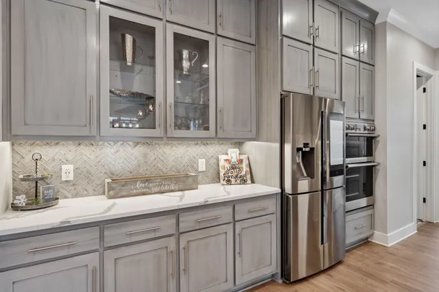 a kitchen with stainless steel appliances granite countertop a sink and a stove