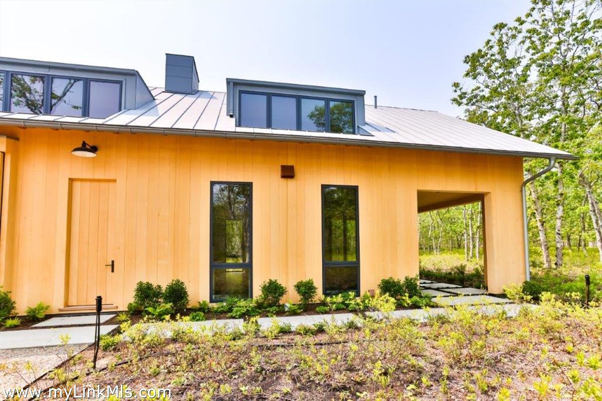 4 Jacob's Neck Road Edgartown, MA 02539 - Photo 9 of 20 a front view of a house with many windows