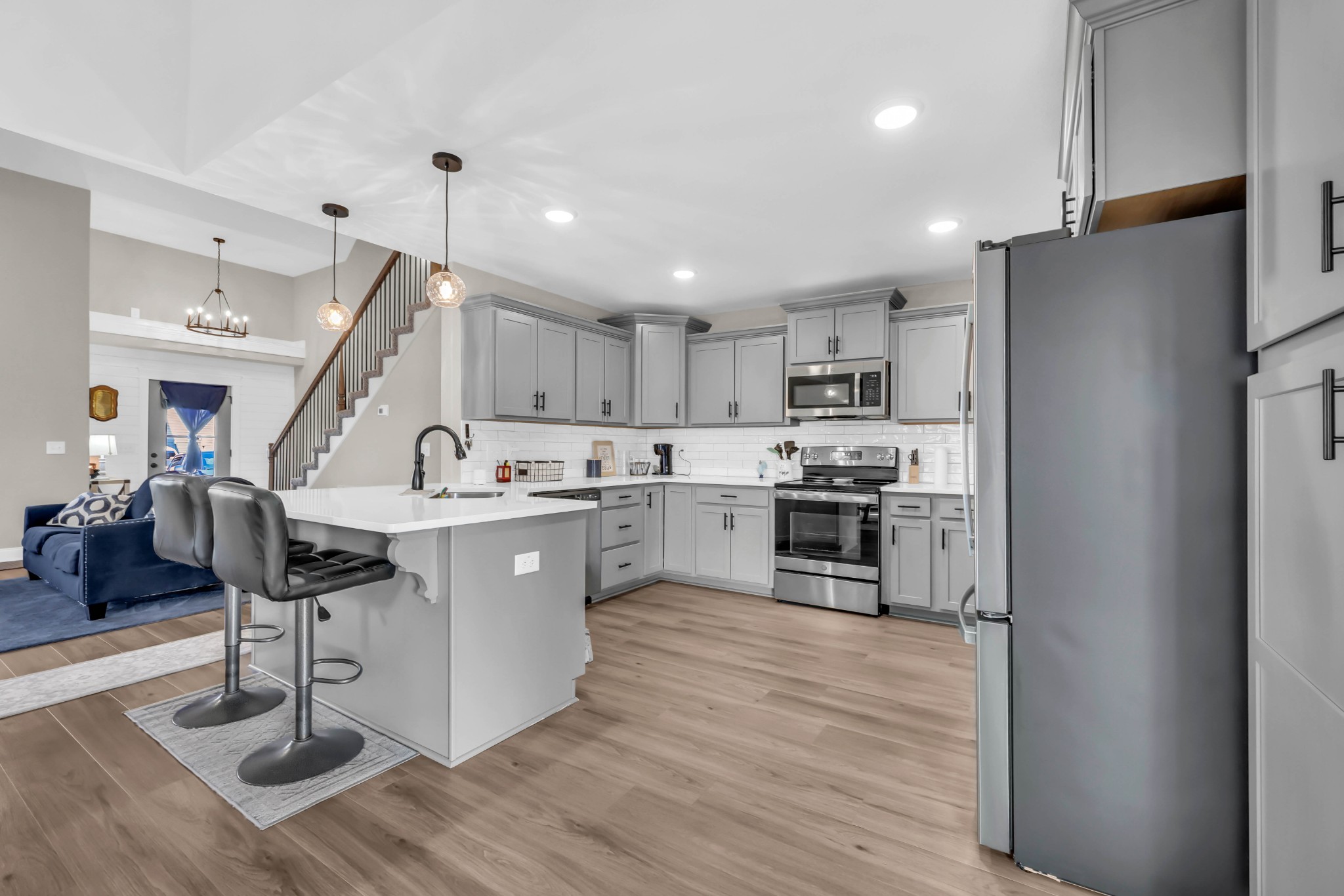 a kitchen with stainless steel appliances kitchen island a refrigerator and a stove top oven