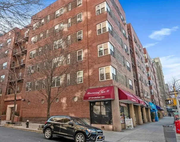 a front view of a building with parking space