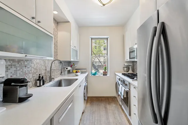 a kitchen with a sink a stove and refrigerator
