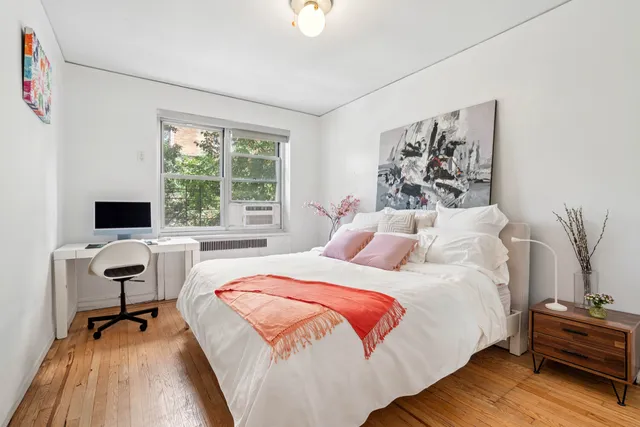 a bedroom with a bed and a desk