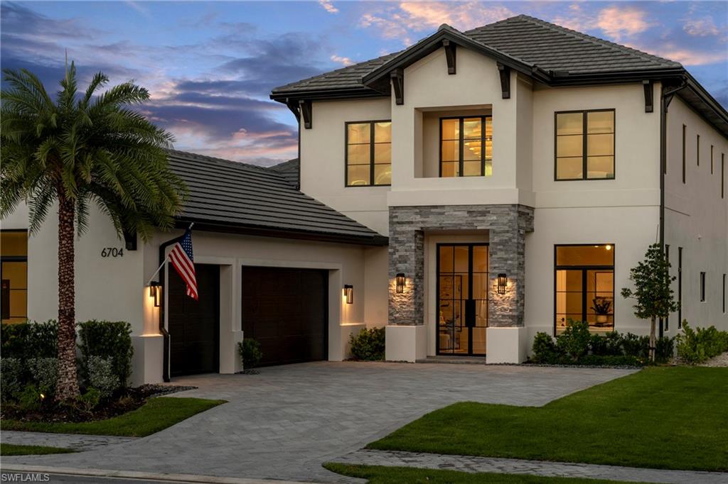 6704 Newport Road Naples, FL 34109 - Photo 1 of 47 a front view of a house with a yard and garage