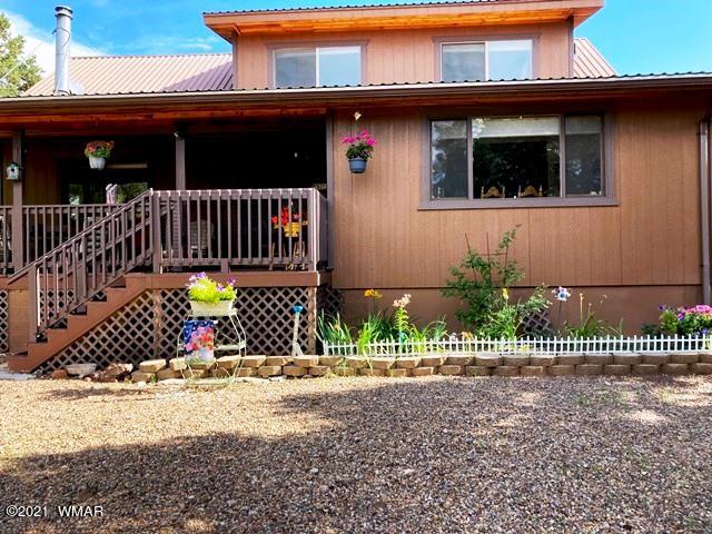 2091 Ranger Road Overgaard, AZ 85933 - Photo 1 of 66 a view of a house with a small yard and wooden fence