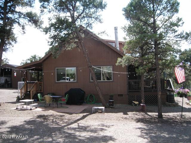 2091 Ranger Road Overgaard, AZ 85933 - Photo 59 of 66 a backyard of a house with barbeque oven and outdoor seating