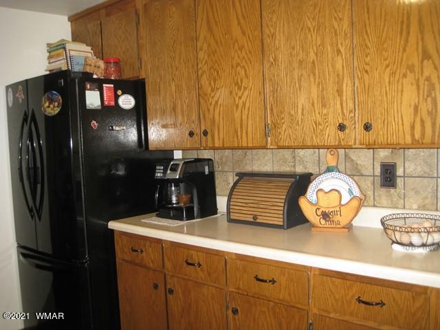 2091 Ranger Road Overgaard, AZ 85933 - Photo 8 of 66 a kitchen with a sink and a refrigerator