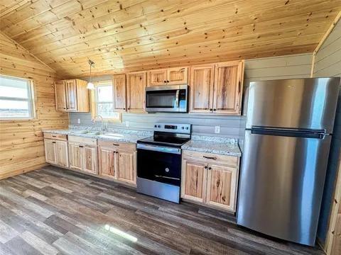 323 Blue Cat Boulevard Haskell, TX 79521 - Photo 6 of 18 Kitchen featuring knotty wood cabinetry and light-toned countertops