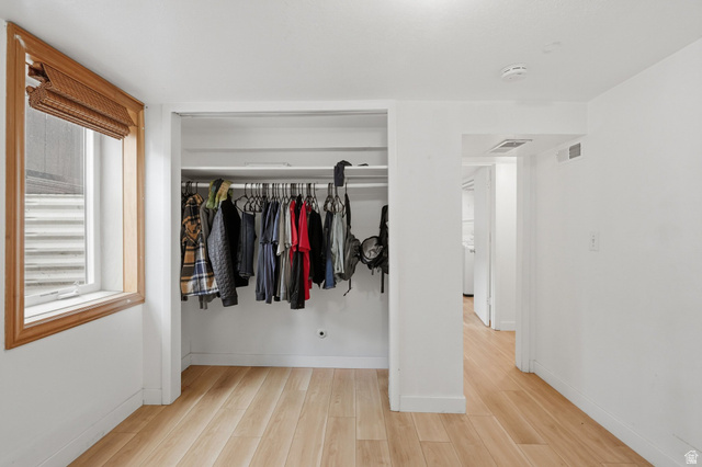 707 East 150 South Provo, UT 84606 - Photo 22 of 31 Bedroom #4 Interior room featuring light wood-finish flooring, white walls, and a recessed clothing closet with hanging rod