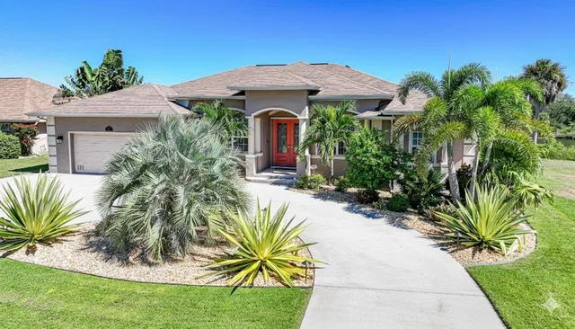 a view of a lake with a yard and large trees