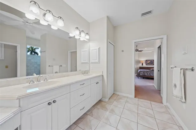 a large kitchen with a counter space a sink and living room view