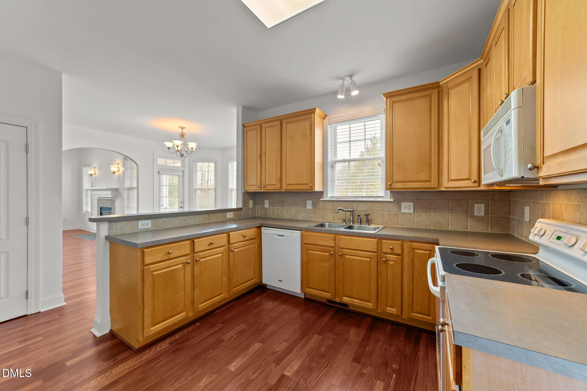 7101 Numa Circle Willow Spring, NC 27592 - Photo 11 of 44 a kitchen with stainless steel appliances granite countertop wooden cabinets a sink and a stove