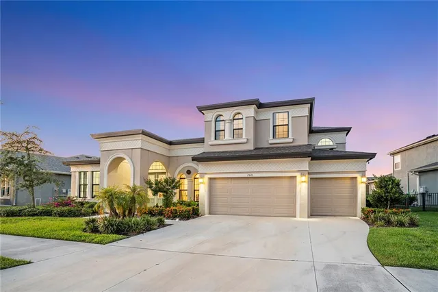 a front view of a house with a garden and parking