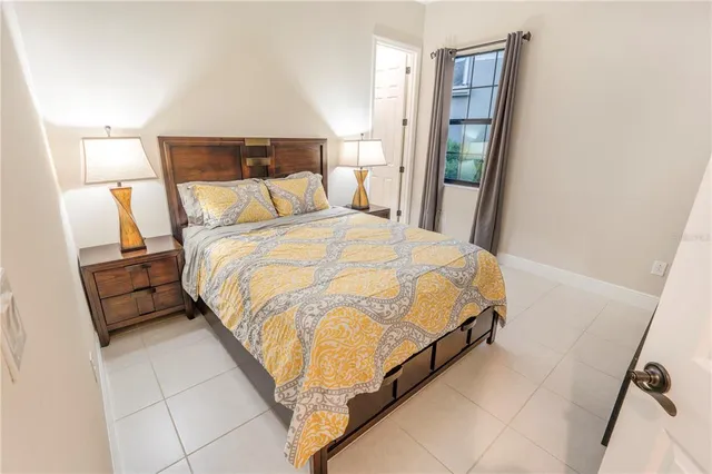 a bed sitting in a bedroom next to a walk in closet