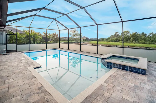 a view of a swimming pool with a lounge chair