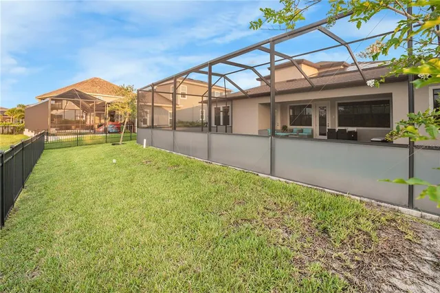 a view of a house with a backyard and a patio
