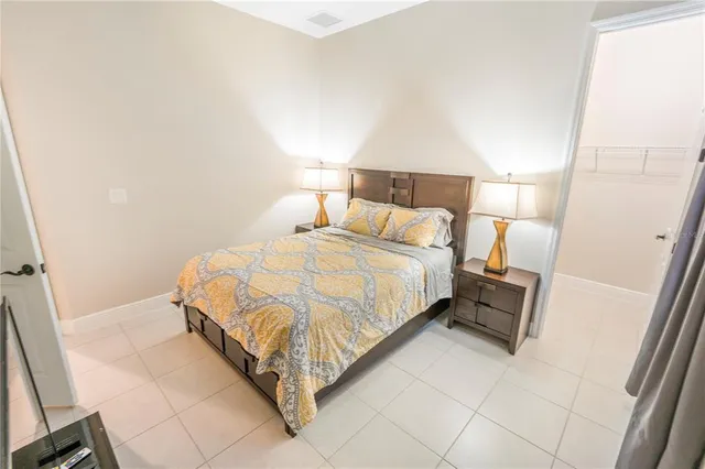 a bedroom with a bed and lamp